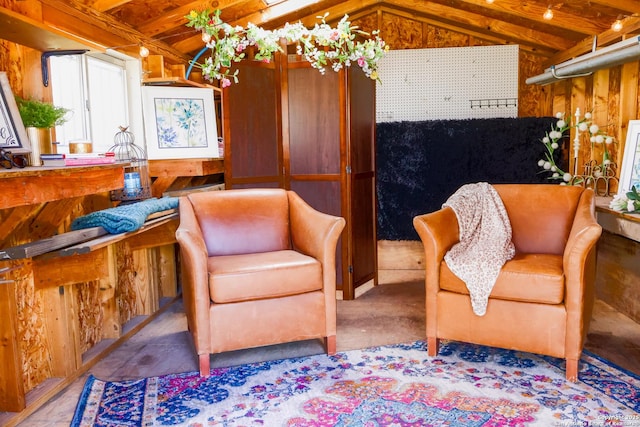 sitting room featuring wood walls, wooden ceiling, and vaulted ceiling with beams