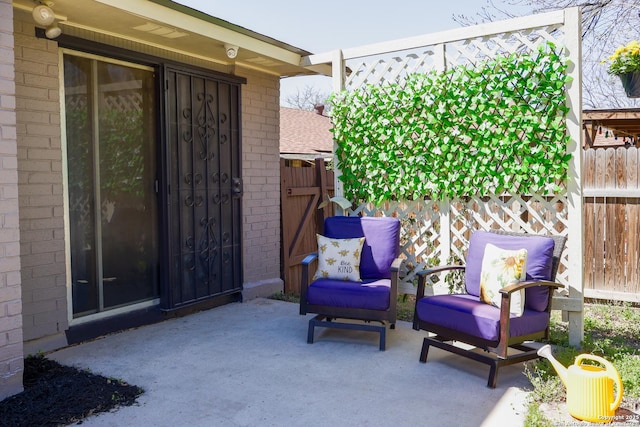 view of patio featuring fence