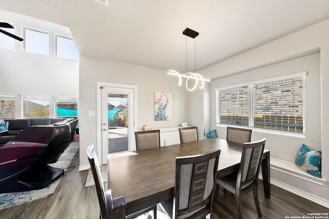 dining space with a healthy amount of sunlight, dark wood-style flooring, and baseboards