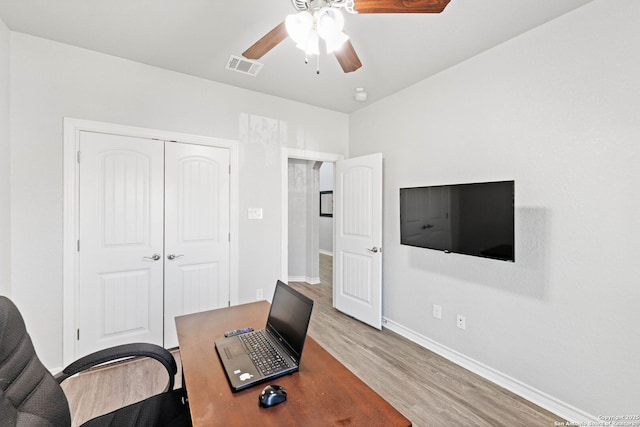 office space featuring visible vents, baseboards, ceiling fan, and wood finished floors