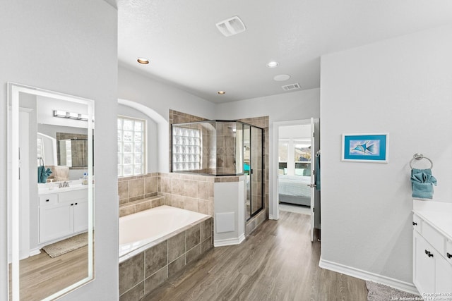 full bath with a wealth of natural light, a shower stall, and vanity