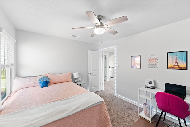 bedroom featuring visible vents, ceiling fan, and carpet