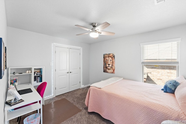 carpeted bedroom featuring a closet and a ceiling fan