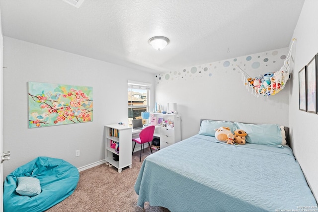 bedroom featuring baseboards, light colored carpet, and a textured ceiling