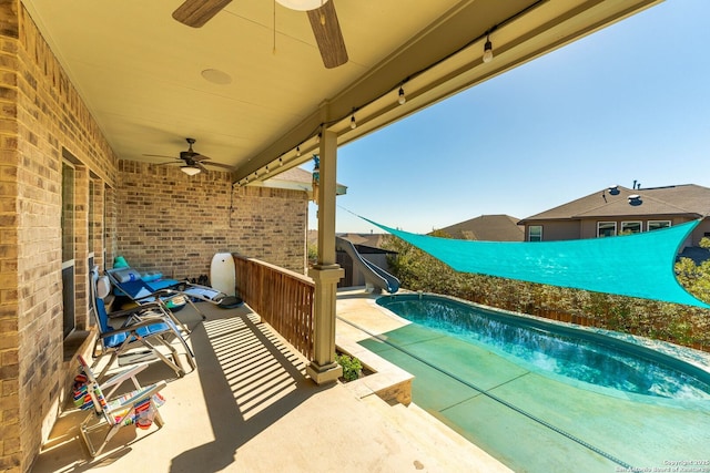 view of pool with a patio area, a fenced in pool, and a water slide