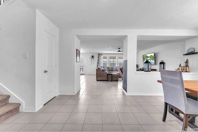 tiled dining space featuring stairway, baseboards, and ceiling fan