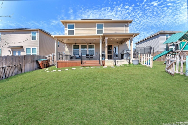 back of property featuring a lawn, a playground, and a fenced backyard