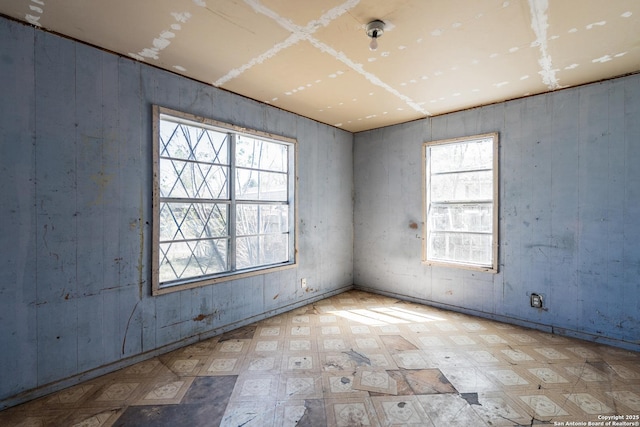 spare room with tile patterned floors and a healthy amount of sunlight