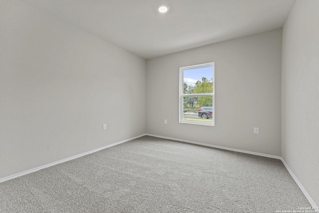 unfurnished room featuring carpet flooring and baseboards