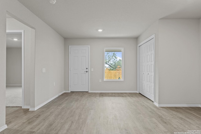 foyer with recessed lighting, baseboards, and wood finished floors