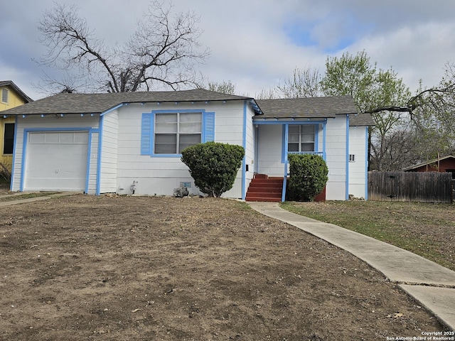 view of front of house with fence and a garage