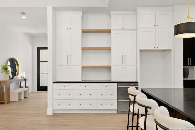 kitchen with light wood-type flooring, recessed lighting, hanging light fixtures, white cabinetry, and open shelves