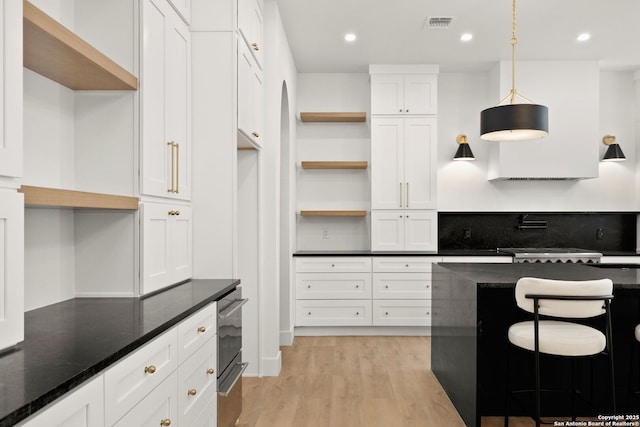 kitchen featuring open shelves, light wood-style floors, and white cabinetry