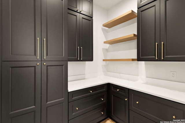 kitchen featuring light countertops and open shelves