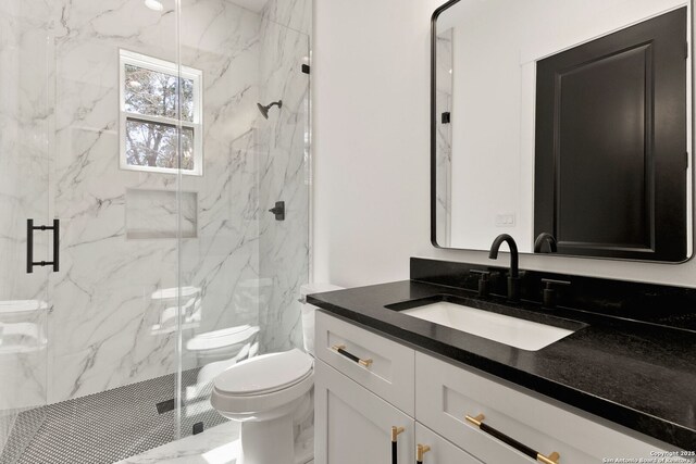 full bath with a marble finish shower, marble finish floor, toilet, and vanity