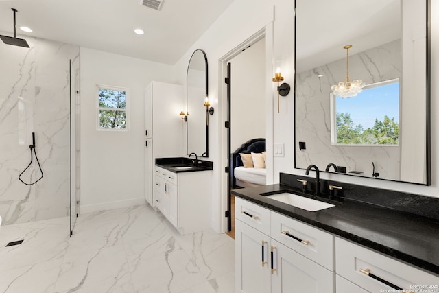 ensuite bathroom with recessed lighting, marble finish floor, a marble finish shower, and a sink