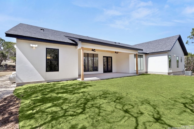 rear view of property with stucco siding, cooling unit, a lawn, a patio area, and a ceiling fan