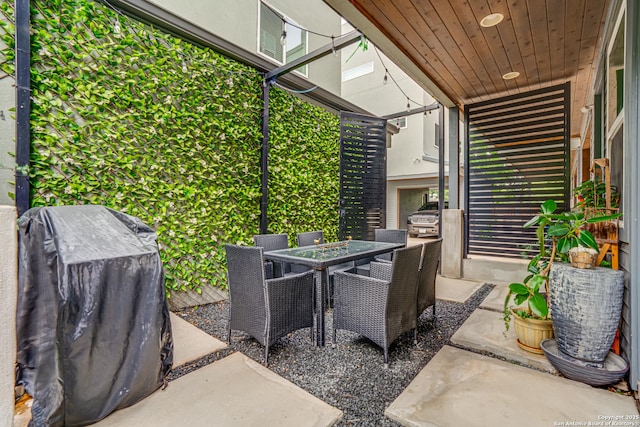 view of patio featuring outdoor dining area and a grill