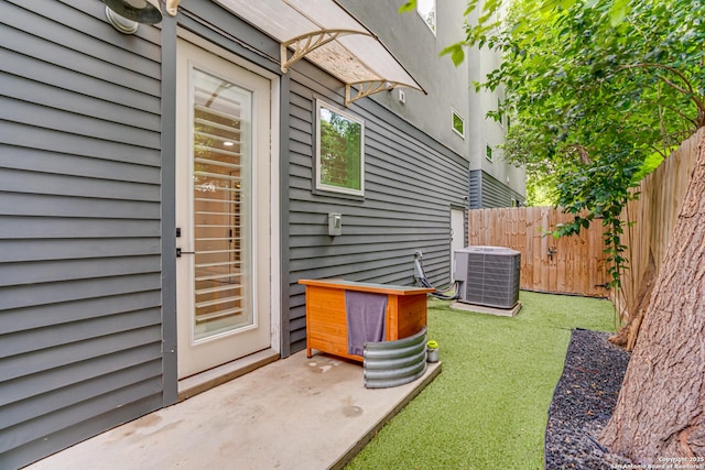 property entrance with central air condition unit and fence