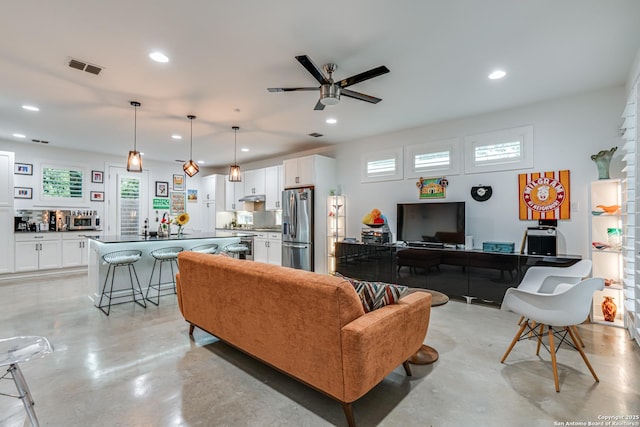 living room with visible vents, recessed lighting, concrete floors, and ceiling fan