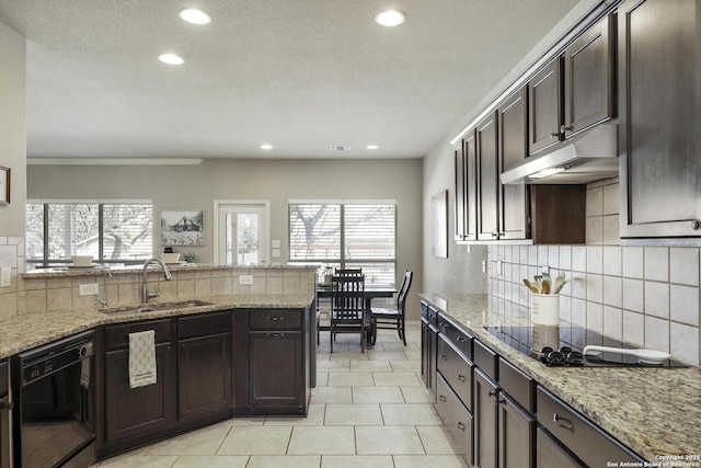 kitchen with light tile patterned flooring, a sink, black appliances, dark brown cabinets, and under cabinet range hood