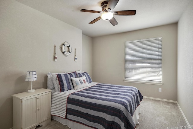 bedroom featuring ceiling fan, baseboards, and light carpet