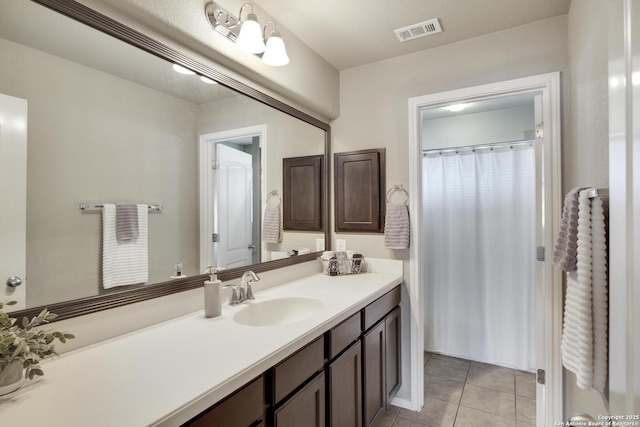 bathroom featuring tile patterned flooring, visible vents, vanity, and a shower with shower curtain