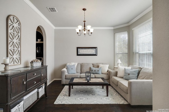 living area featuring dark wood-type flooring, baseboards, visible vents, and ornamental molding