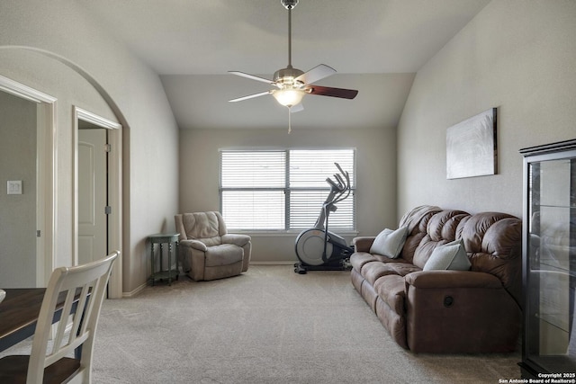 living area featuring baseboards, carpet floors, a ceiling fan, and vaulted ceiling