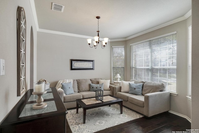 living area with visible vents, crown molding, and dark wood-style flooring