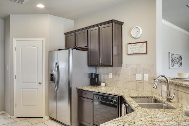 kitchen featuring light stone counters, a sink, decorative backsplash, dark brown cabinetry, and dishwasher