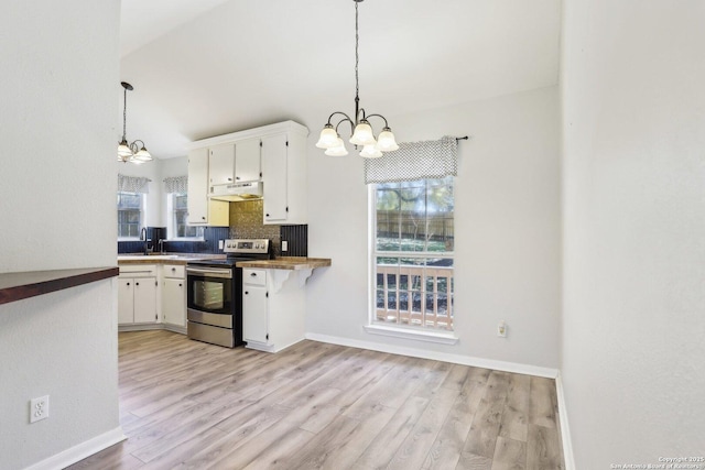 kitchen featuring an inviting chandelier, stainless steel electric stove, decorative backsplash, white cabinets, and under cabinet range hood