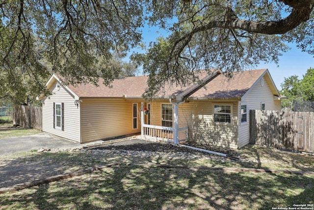 single story home with fence and a shingled roof