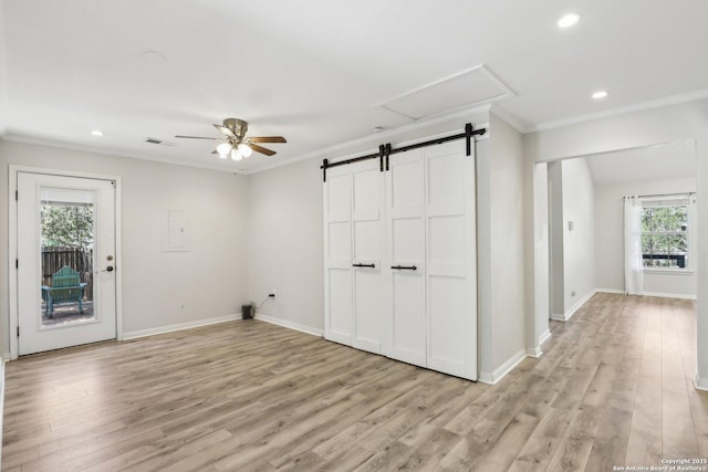 interior space with crown molding, light wood-style floors, visible vents, and baseboards