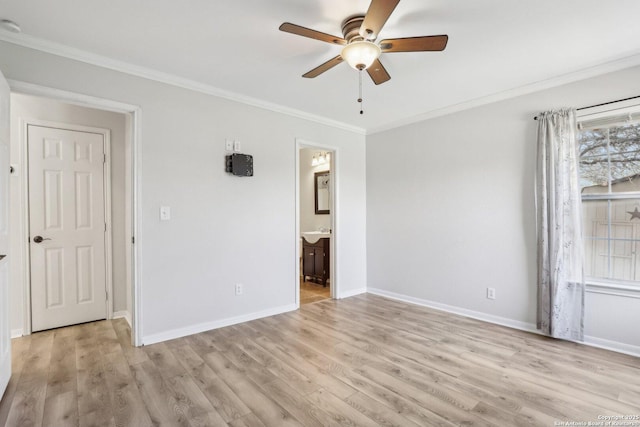 unfurnished bedroom featuring crown molding, baseboards, and light wood finished floors