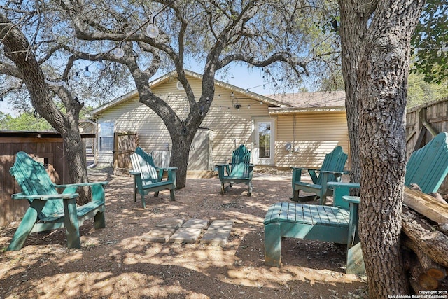 rear view of property with fence