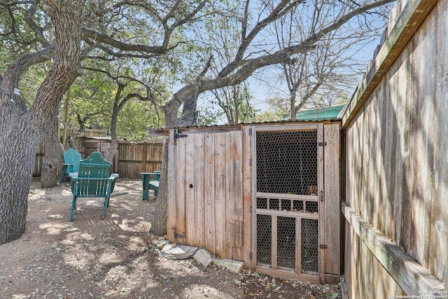 view of outdoor structure with an outbuilding and fence