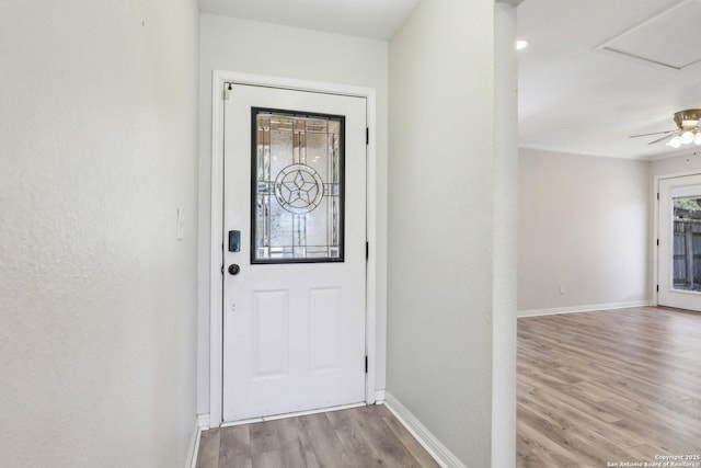 doorway to outside featuring light wood-style flooring and baseboards