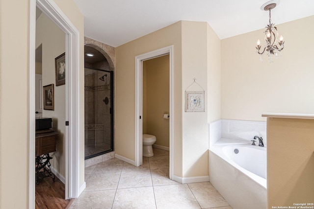 bathroom featuring a bath, a shower stall, tile patterned floors, and toilet