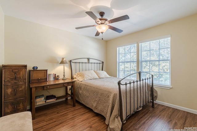 bedroom featuring ceiling fan, baseboards, and wood finished floors