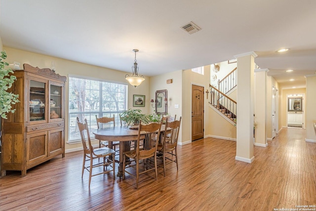 dining room featuring recessed lighting, stairway, baseboards, and light wood-style floors