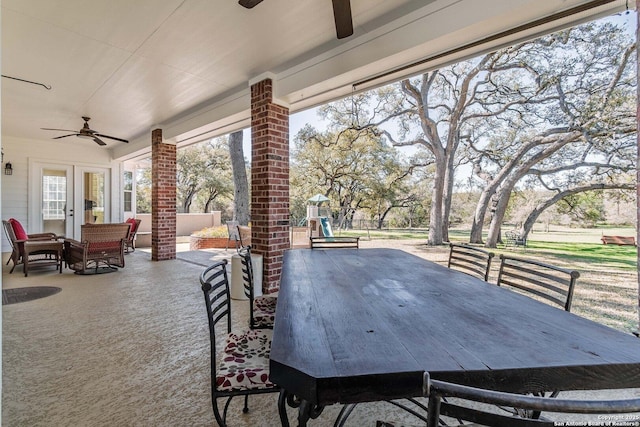 view of patio featuring french doors, outdoor dining space, a ceiling fan, and a playground