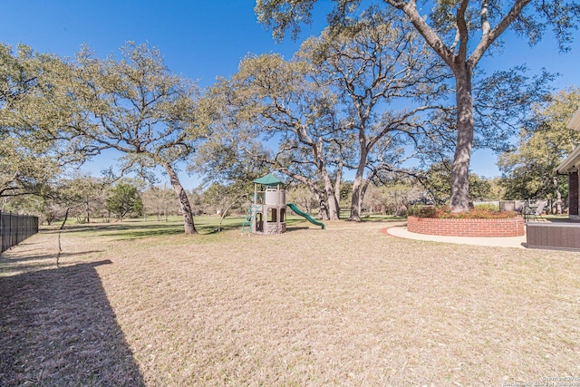 community playground featuring a lawn and fence