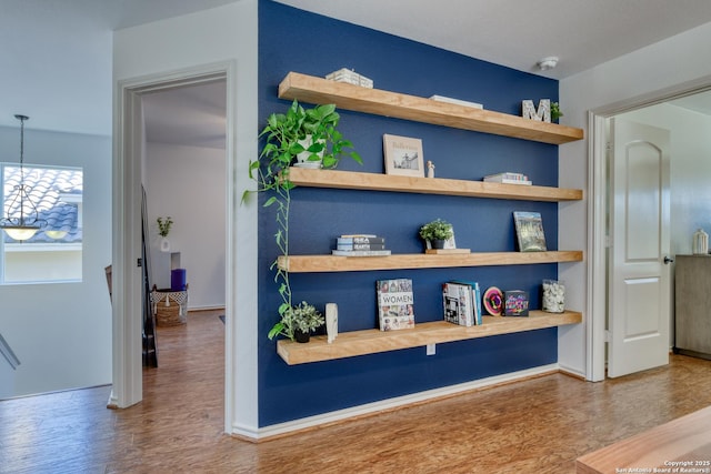 interior details featuring wood finished floors and baseboards