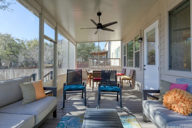 sunroom / solarium featuring ceiling fan