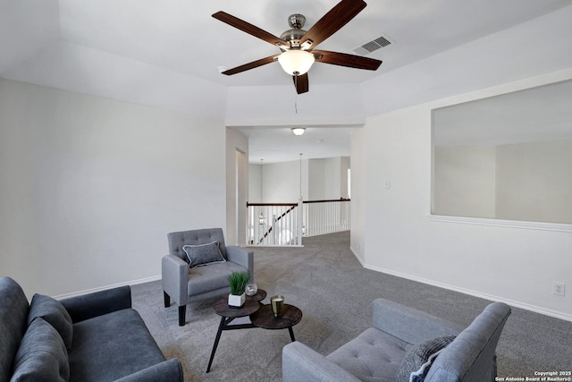 carpeted living area with visible vents and baseboards