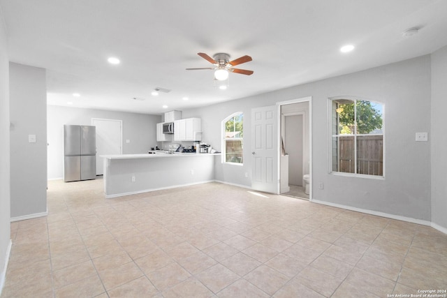 unfurnished living room with recessed lighting, baseboards, ceiling fan, and light tile patterned flooring