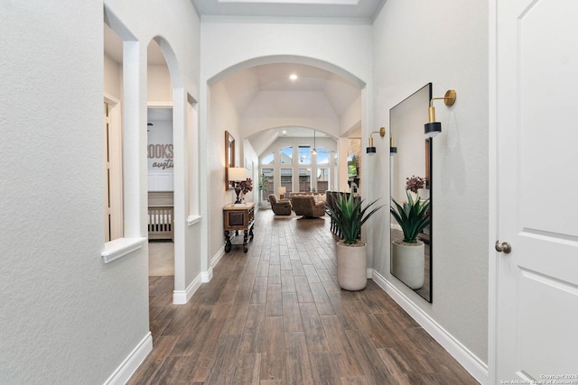 corridor featuring baseboards and dark wood-style floors