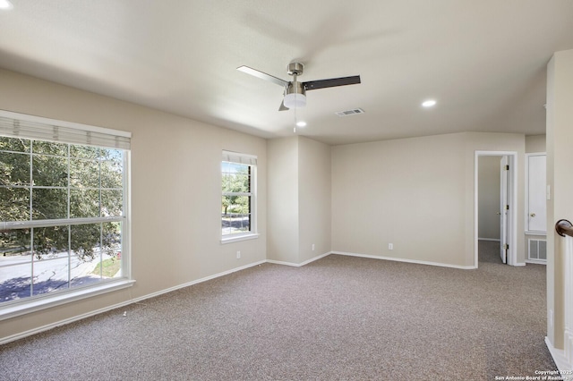 unfurnished room with visible vents, carpet, and ceiling fan