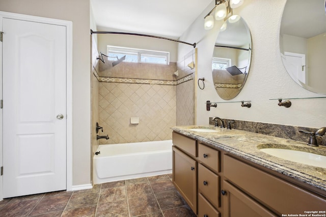 bathroom featuring bathtub / shower combination, double vanity, and a sink